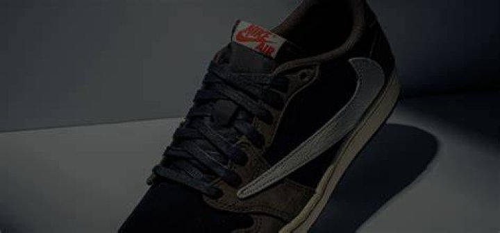 A sneaker close up on a woman wearing black running shoes.