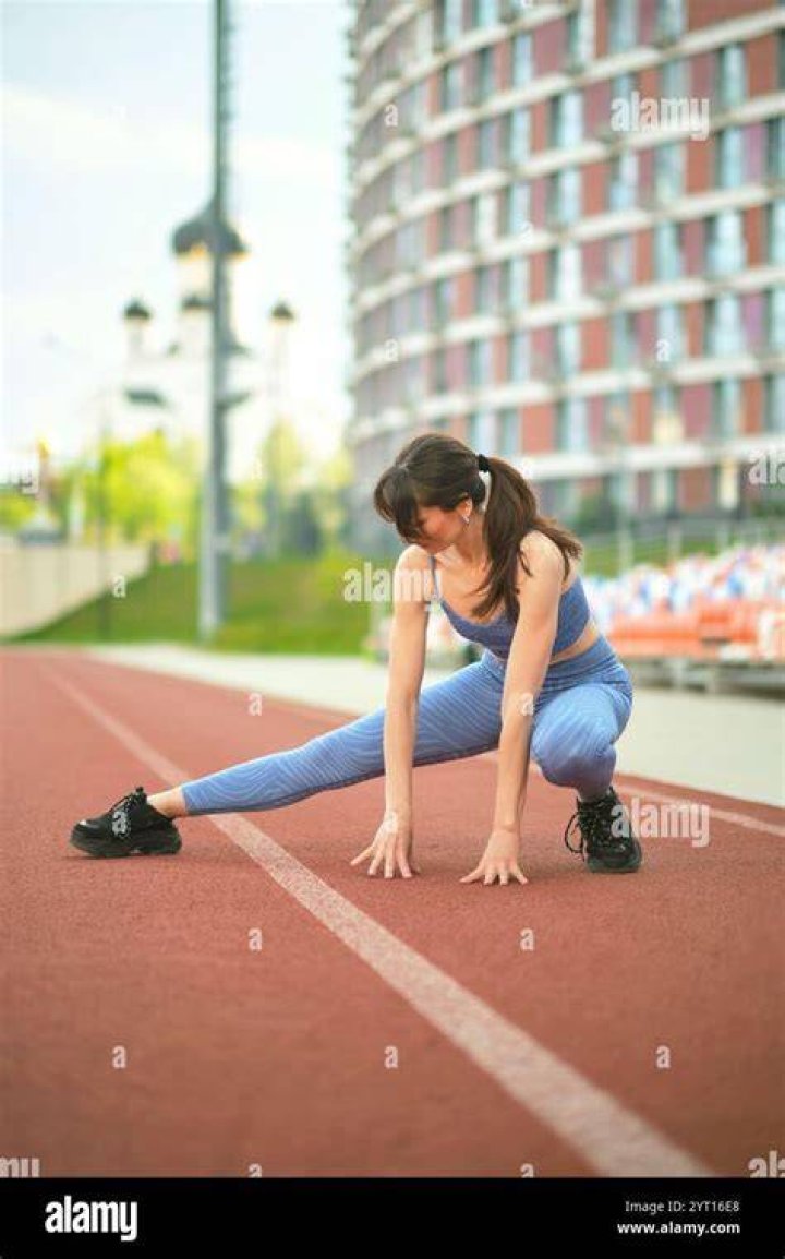 A woman in athletic gear and black running shoes