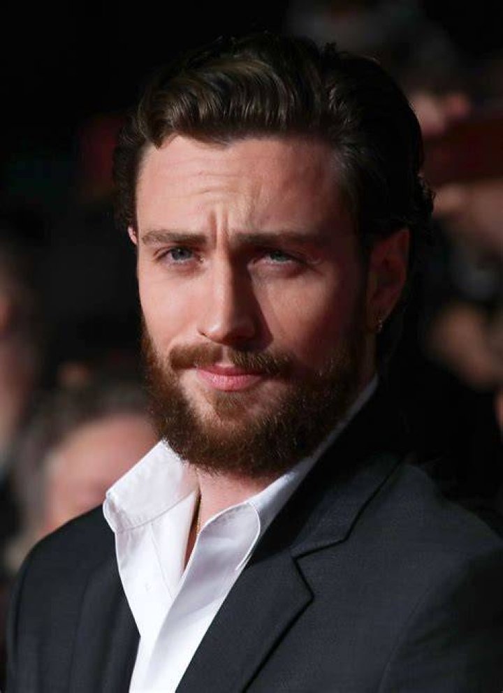 Aaron Taylor-Johnson looking at someone in a scene from Kraven The Hunter's first trailer.