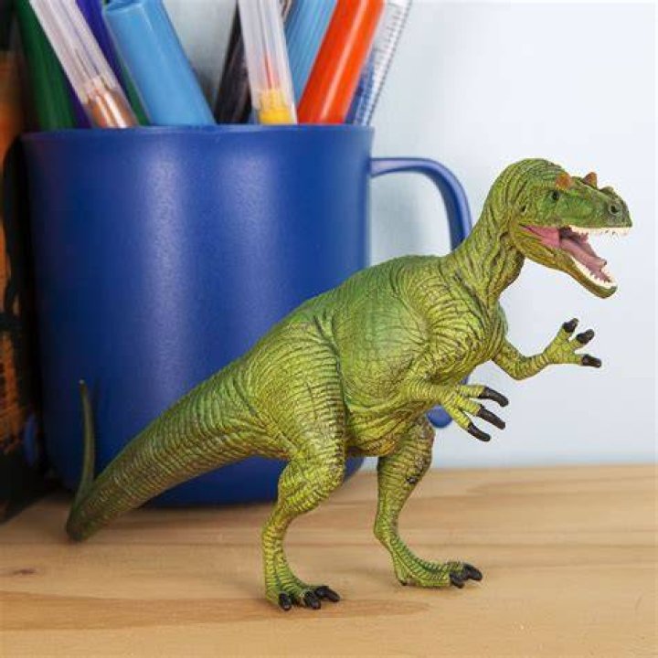 An Allosaurus in a pen in Jurassic World: Evolution