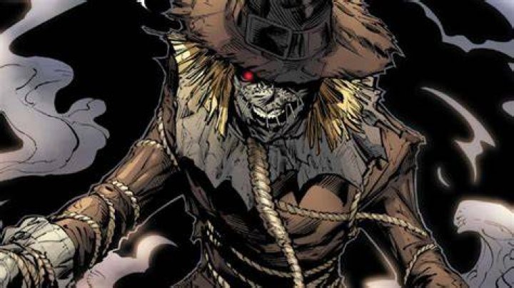 Batman villain The Scarecrow doing a scary pose with his hands while wearing his iconic mask