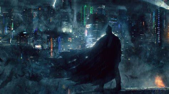Batman watching over Gotham on a comic cover.