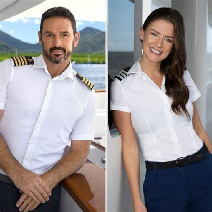 Below Deck Jason Chambers Love Life Dating Aesha ScotBelow Deck Down Under star Jason Chambers wearing a suit and looking serious with blue and orange background photos