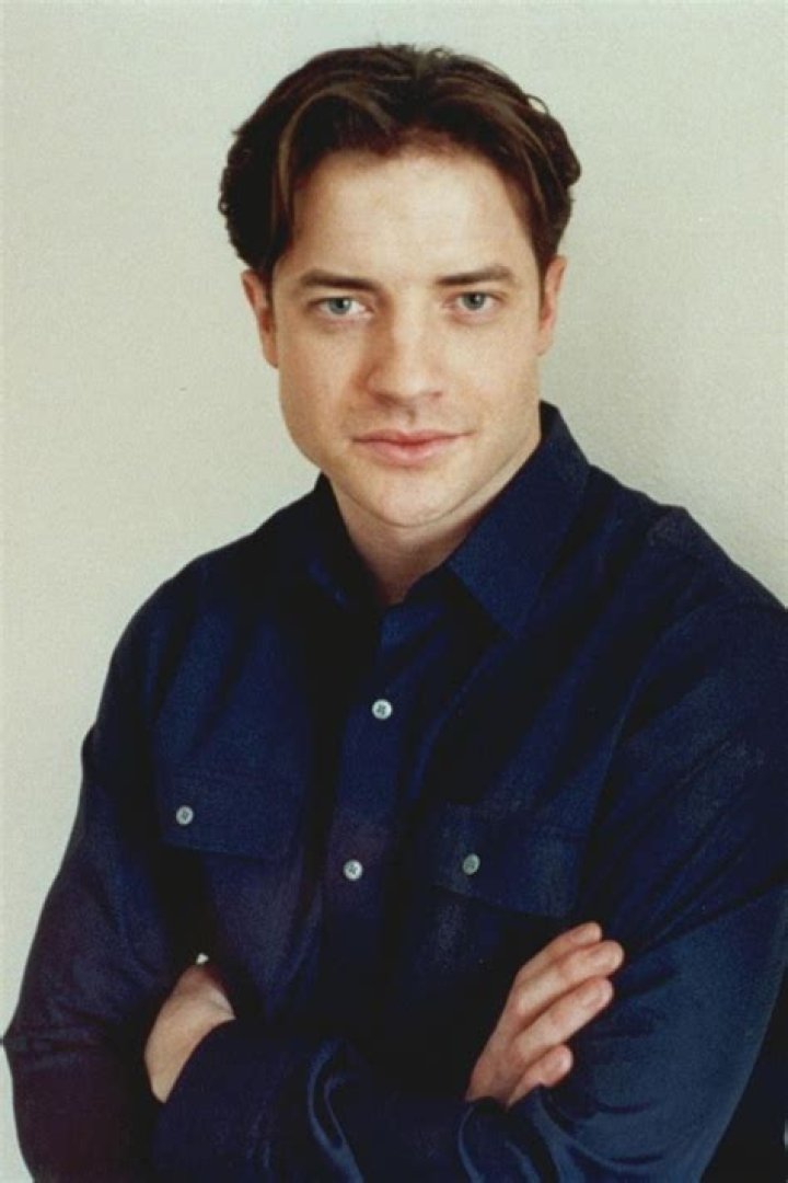 Brendan Fraser gives a peace sign in Now and Then