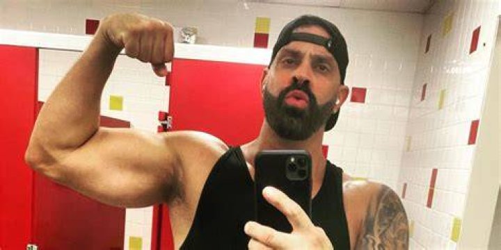 Christopher Larangeira flexing in bathroom