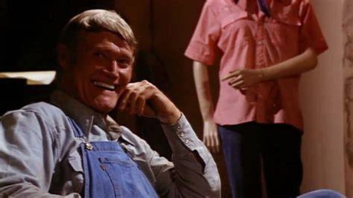 Chuck Connors as Mr. Slausen sitting with his shotgun in Tourist Trap (1979)