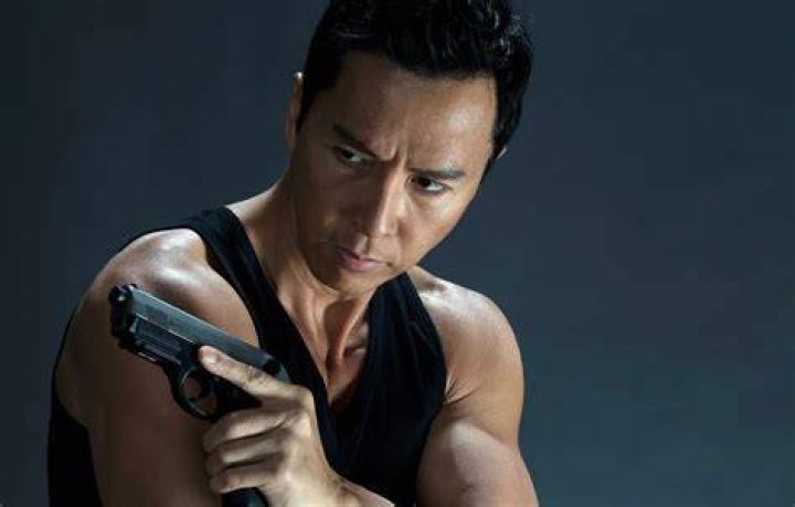 Donnie Yen points a gun in John Wick Chapter 4