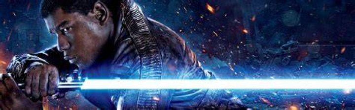 Finn with a lightsaber in The Force Awakens