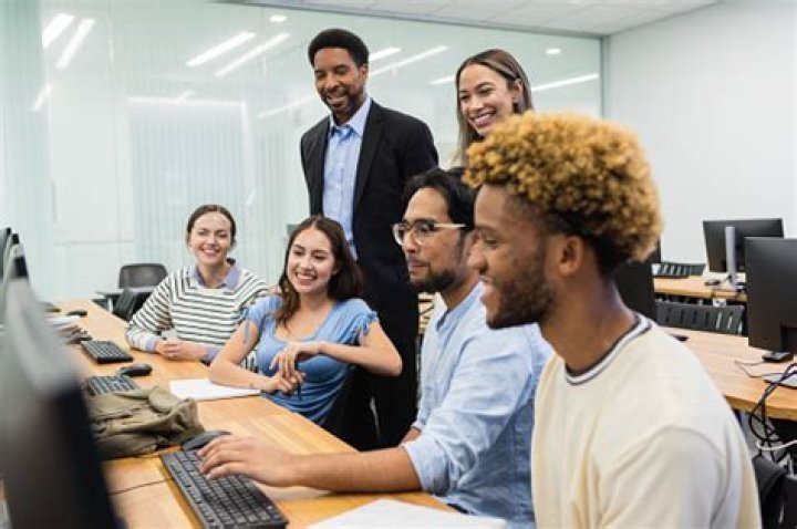 group of interns smiling and laughing in a cafe