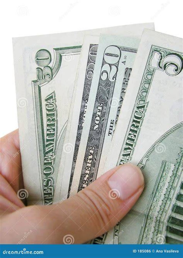 hand holding dollar notes