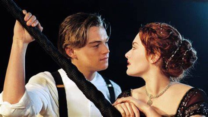 Jack and Rose look at each other in the hall, Rose holds his arm
