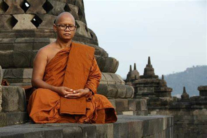 Jason in his Buddhist monk clothes explaining something
