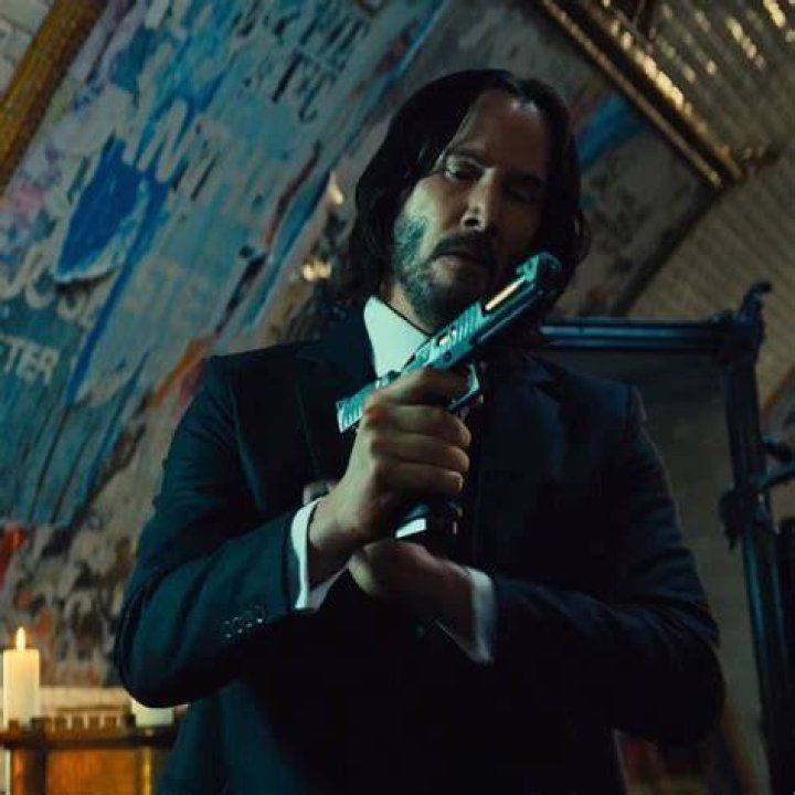 John Wick and a pit bull walk over a bridge in John Wick Chapter 3 Parabellum
