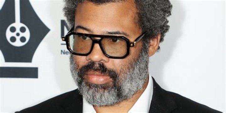 Jordan Peele in front of a cloud image from Nope