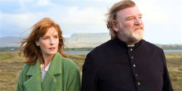 Kelly Reilly standing with Brendan Gleeson in Calvary