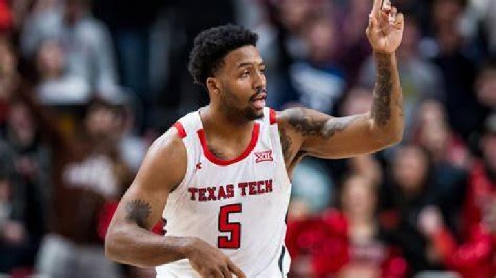 KJ Allen with his arms crossed posing for the camera in Last Chance U: Basketball