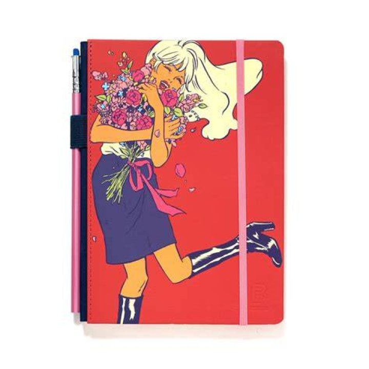 Leslie holding a notebook in Rebecca's office