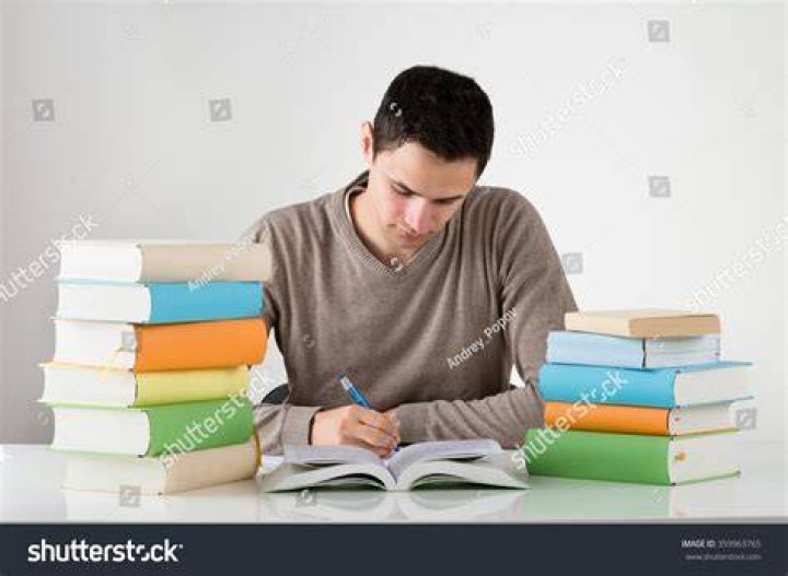 man at table writing