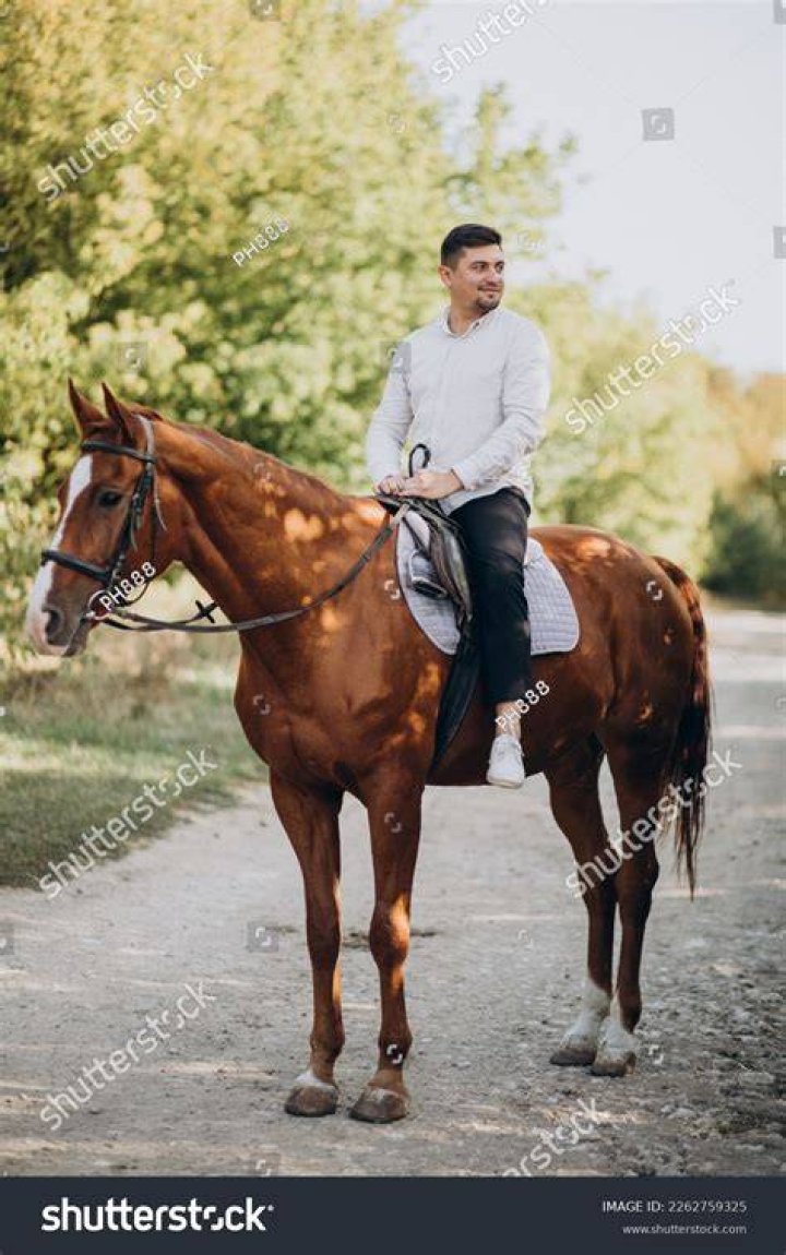 man riding a horse on water