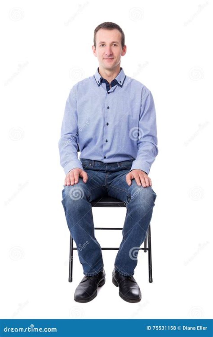man sitting on chair in front on window during daytime