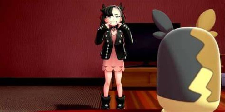 Marnie pushes the corners of her lips up before Morpeko in Sword & Shield's post-game
