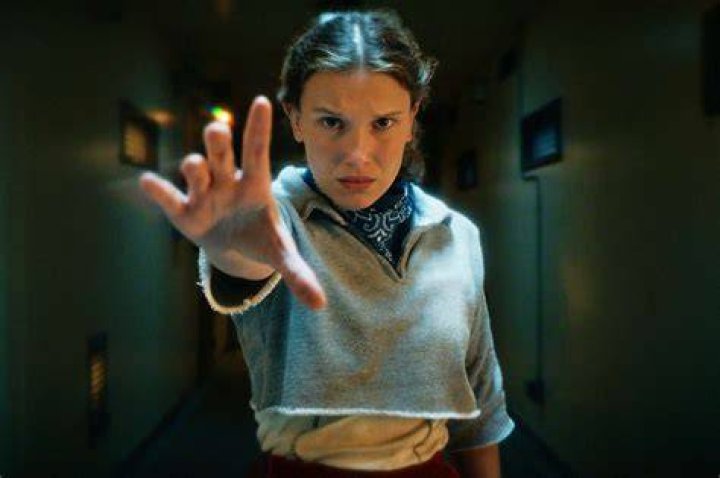 Millie Bobby Brown as Eleven looking worried in Stranger Things.