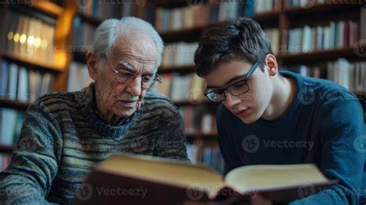old man showing a young boy how to use a tool