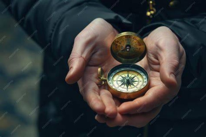 person holding out compass