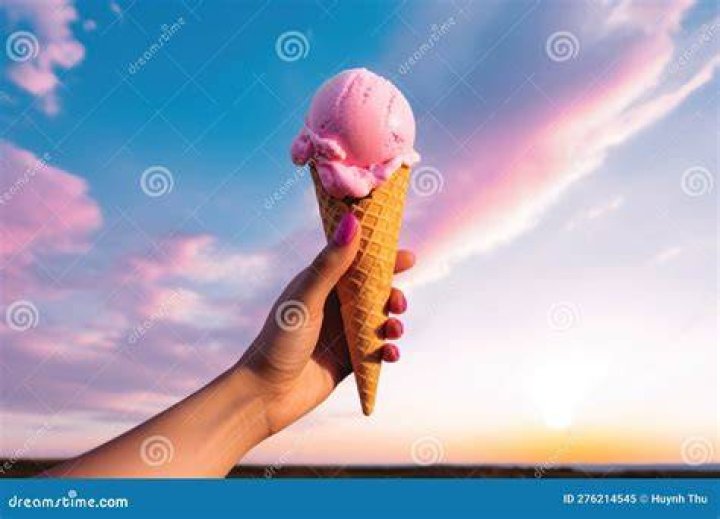person holding up a cone full of chocolate gelato in venice italy