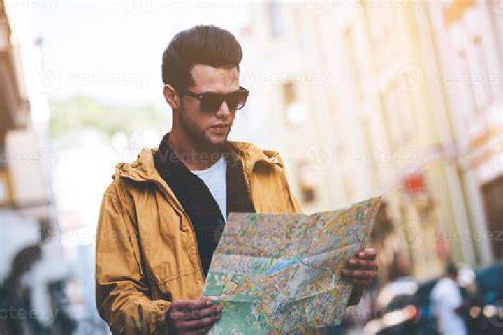 person looking at map in a car