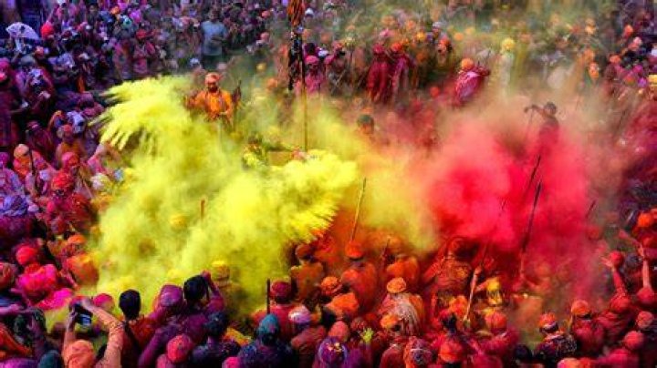 person posing during holi festival in india