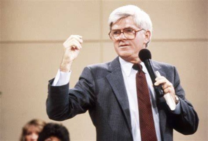 Phil Donahue holding a microphone on his talk show from the '90s.