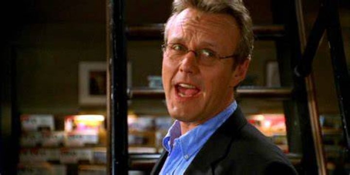 Rupert Giles talks to someone off-screen in Buffy the Vampire Slayer.