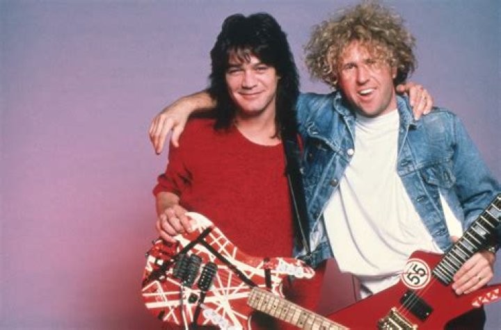 Sammy Hagar and Eddie Van Halen shaking hands on stage