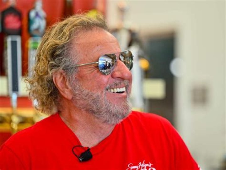 Sammy Hagar in an orange tee and Eddie Van Halen at a concert