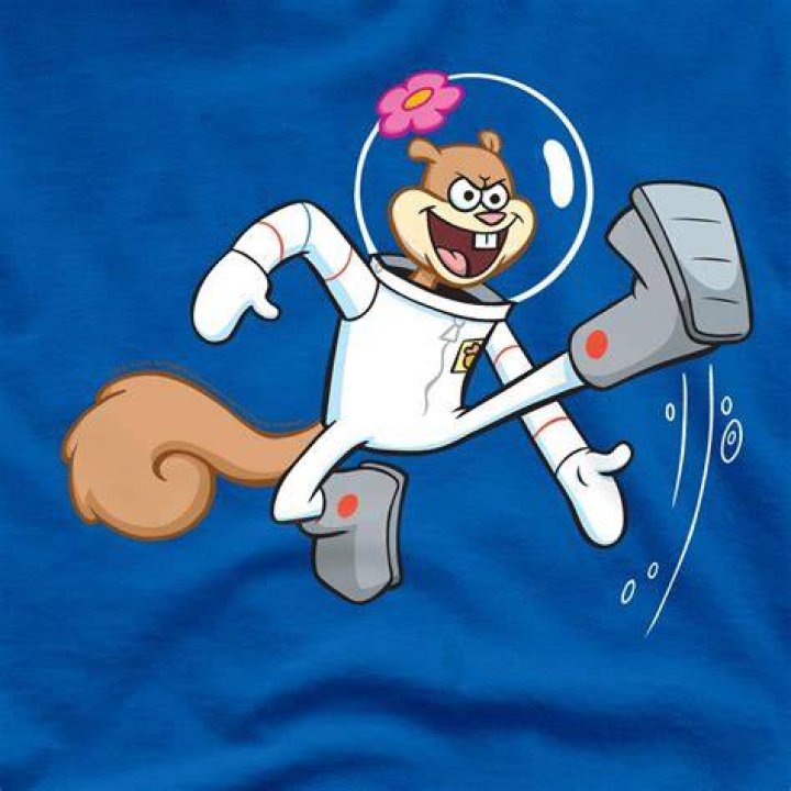 Sandy is ready to karate chop someone.