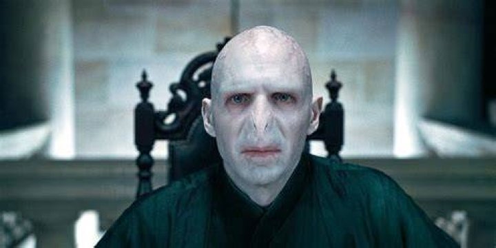 Split image of Voldemort sitting on chair and Peter Pettigrew holding small, semi-formed Voldemort