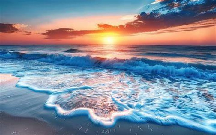 Sunset glow over beach and surrounding landscape