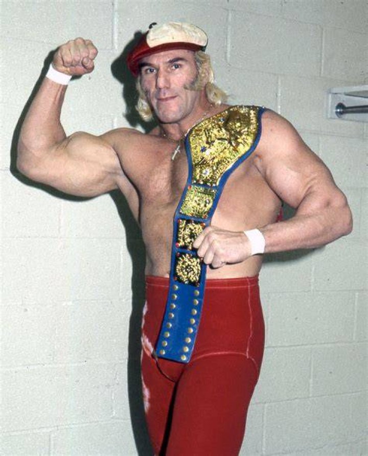 Superstar Billy Graham flexing with the WWE Championship
