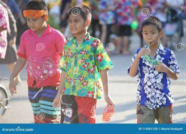 thai kids playing in water