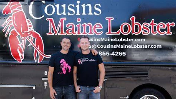 The founders of Cousin Maine Lobster showing off their food truck
