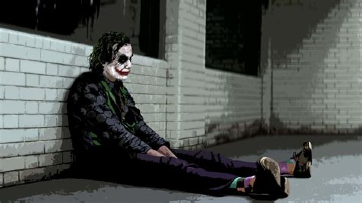 The Joker sitting on a sofa chair with a smile on the cover of THE JOKER #1
