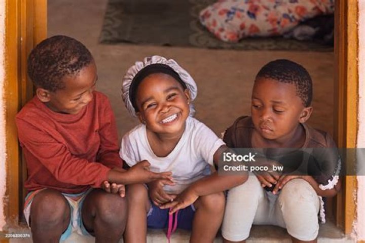 Three smiling African children with supper