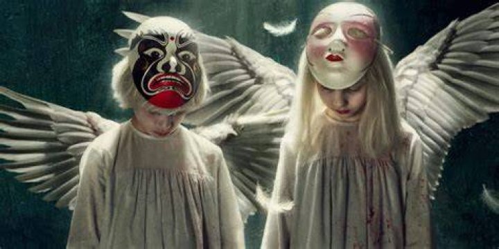 Tin and Tina wear masks and angel wings in a promo image for Tin & Tina