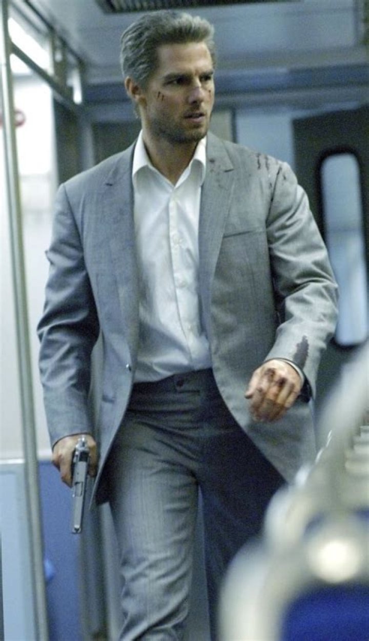 Tom Cruise as Vincent clutching a handgun and hunting down Max in Michael Mann's Collateral.