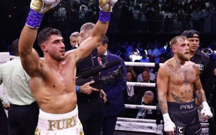 Tommy Fury puts his hand to his face and poses topless for a Love Island promo image