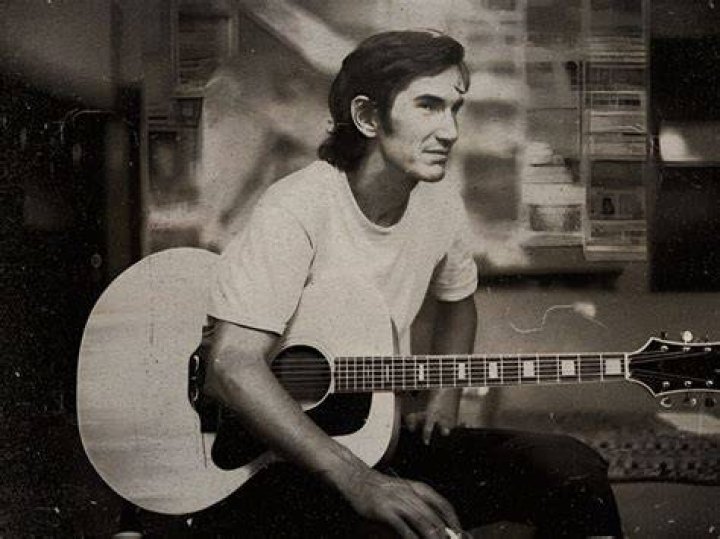 Townes Van Zandt sings while a man listens from Heartworn Highways