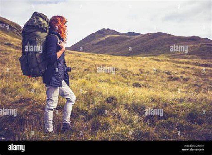 woman backpacking through wilderness