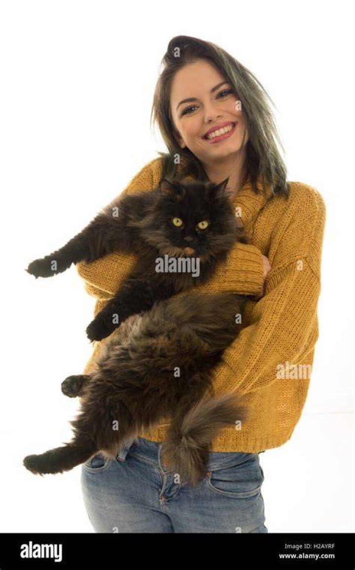 woman carrying cat in a carrier