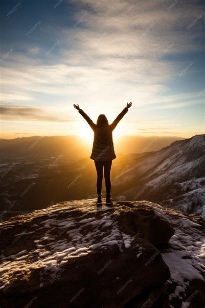 woman standing on mountaintop
